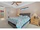 Tranquil main bedroom with a tray ceiling, complemented by wood nightstands and soft lamps at 6528 Coopers Hawk Ct, Lakewood Ranch, FL 34202