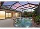 Relaxing pool features a screen enclosure with a covered patio with a beautiful sky at 6528 Coopers Hawk Ct, Lakewood Ranch, FL 34202