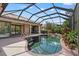Sparkling pool with a screened enclosure, perfect for outdoor relaxation and entertaining near the sliding door at 6528 Coopers Hawk Ct, Lakewood Ranch, FL 34202