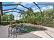 Sparkling pool features a screen enclosure and tropical landscaping with lush plants at 6528 Coopers Hawk Ct, Lakewood Ranch, FL 34202