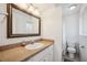 Bathroom with white vanity, sink, framed mirror, and shower/tub with polka-dot shower curtain at 6860 Whitman Ct # 32B, Sarasota, FL 34243