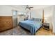 Bedroom featuring a four-poster bed with blue comforter, a dresser, and a nightstand at 6860 Whitman Ct # 32B, Sarasota, FL 34243