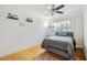 Bedroom featuring a bed with grey comforter, wood floor, a ceiling fan, and natural light at 6860 Whitman Ct # 32B, Sarasota, FL 34243