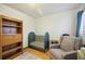 Bedroom showcasing a crib, cozy armchair, and shelving unit, ideal for a growing Gathering at 6860 Whitman Ct # 32B, Sarasota, FL 34243