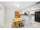 Dining area with tile floors, a wooden table, and easy access to kitchen for convenient serving at 6860 Whitman Ct # 32B, Sarasota, FL 34243