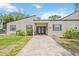 Welcoming exterior of a charming single-story building with a brick walkway and well-maintained landscaping at 6860 Whitman Ct # 32B, Sarasota, FL 34243