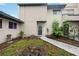 Clean exterior with neutral colors, simple landscaping, and defined walkway leading to the entrance at 6860 Whitman Ct # 32B, Sarasota, FL 34243