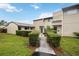 Inviting home featuring a manicured lawn, symmetrical shrubs and a well-maintained facade at 6860 Whitman Ct # 32B, Sarasota, FL 34243