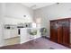Bright kitchenette featuring a breakfast bar, white cabinets, and essential appliances at 6860 Whitman Ct # 32B, Sarasota, FL 34243