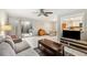 Bright living room featuring tile flooring, modern fan, neutral walls and sliding glass doors to the outside at 6860 Whitman Ct # 32B, Sarasota, FL 34243