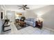 Cozy living room with tile floors, ceiling fan, and a nautical-themed rug under the coffee table at 6860 Whitman Ct # 32B, Sarasota, FL 34243