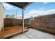Cozy back patio area with a wooden deck and privacy fence at 6860 Whitman Ct # 32B, Sarasota, FL 34243