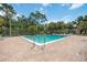 Serene pool with clear water, surrounded by a brick patio and lush trees, creating a private oasis at 6860 Whitman Ct # 32B, Sarasota, FL 34243