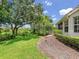 Lush backyard featuring manicured landscaping, mature trees, and a scenic view of the adjacent natural area at 7003 Lancaster Ct, University Park, FL 34201
