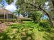 Expansive backyard with lush lawn, mature trees, and manicured landscaping offering a private outdoor retreat at 7003 Lancaster Ct, University Park, FL 34201