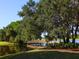 Scenic community view featuring a charming wooden bridge over a serene lake surrounded by lush landscaping at 7003 Lancaster Ct, University Park, FL 34201