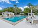 Inviting community pool featuring poolside seating and a shaded area, perfect for relaxation and socializing at 7003 Lancaster Ct, University Park, FL 34201