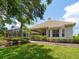 Well-maintained home exterior featuring a tile roof, screened lanai, and lush landscaping at 7003 Lancaster Ct, University Park, FL 34201