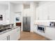 Open kitchen features stainless steel appliances, granite countertops, white cabinets, and hardwood flooring at 7003 Lancaster Ct, University Park, FL 34201