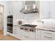 Modern kitchen design boasts stainless steel appliances, granite countertops, and sleek white cabinets at 7003 Lancaster Ct, University Park, FL 34201