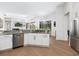 Kitchen features stainless steel appliances, granite countertops, white cabinets, and hardwood flooring at 7003 Lancaster Ct, University Park, FL 34201