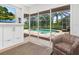 Bright living space with views of the screened pool, featuring a fireplace, TV, and comfortable seating at 7003 Lancaster Ct, University Park, FL 34201