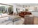Spacious living room with an open layout, showcasing access to outdoor living areas, a kitchen, and a dining area at 7003 Lancaster Ct, University Park, FL 34201