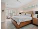 Spacious main bedroom with a large bed, bay window, ceiling fan, and light-colored walls at 7003 Lancaster Ct, University Park, FL 34201