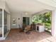 Covered patio with outdoor dining area, kitchen, and view to the pool at 7003 Lancaster Ct, University Park, FL 34201