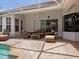 Covered patio with comfortable seating beside the screened-in pool at 7003 Lancaster Ct, University Park, FL 34201
