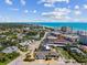 Expansive aerial view of coastal neighborhood homes with beautiful ocean backdrop and blue sky on a sunny day at 714 & 716 Apalachicola Rd, Venice, FL 34285