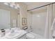Clean bathroom with white vanity, tile floors, and a shower-tub combination with white curtain at 714 & 716 Apalachicola Rd, Venice, FL 34285