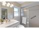 Bright bathroom with a glass-enclosed shower, tile floors, and a modern vanity at 714 & 716 Apalachicola Rd, Venice, FL 34285