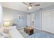 Inviting bedroom featuring a white couch, ceiling fan and double closet at 714 & 716 Apalachicola Rd, Venice, FL 34285