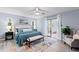 Spacious bedroom featuring a ceiling fan, walk-in closet, and access to the patio at 714 & 716 Apalachicola Rd, Venice, FL 34285