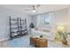 Cozy bedroom featuring a white couch, ceiling fan and wood-look floors at 714 & 716 Apalachicola Rd, Venice, FL 34285
