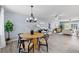 Open-concept dining area features a modern chandelier and flows into the living room at 714 & 716 Apalachicola Rd, Venice, FL 34285