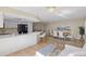 Dining area with wooden table, seating for six, and views of the kitchen and living area at 714 & 716 Apalachicola Rd, Venice, FL 34285