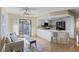 Modern kitchen featuring white cabinets, updated appliances, counter seating and slider to patio at 714 & 716 Apalachicola Rd, Venice, FL 34285