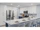 Kitchen featuring stainless appliances, white cabinets and granite countertop breakfast bar at 714 & 716 Apalachicola Rd, Venice, FL 34285