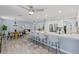Bright kitchen with white cabinets, stainless steel appliances, and a long breakfast bar at 714 & 716 Apalachicola Rd, Venice, FL 34285