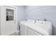 Modern laundry room featuring a utility sink, washer, dryer and back door at 714 & 716 Apalachicola Rd, Venice, FL 34285