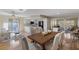 Bright, open-concept living and dining area with wood floors, white kitchen and slider to outdoor space at 714 & 716 Apalachicola Rd, Venice, FL 34285