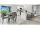 Eat-in kitchen featuring white cabinets, stainless steel appliances, and a view of the yard at 7295 Donahue St, Port Charlotte, FL 33981