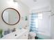Bright bathroom featuring a wood-framed mirror, white vanity, and tiled shower/tub combination at 8007 17Th Nw Ave, Bradenton, FL 34209