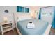 Bright bedroom with a queen bed and ocean-blue curtains by the window featuring a comfortable and serene space at 8007 17Th Nw Ave, Bradenton, FL 34209