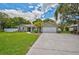 Inviting single-story home featuring a well-maintained lawn and a spacious driveway leading to a garage at 8007 17Th Nw Ave, Bradenton, FL 34209