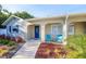 Welcoming front entrance with a vibrant blue door, blue shutters and charming outdoor seating at 8007 17Th Nw Ave, Bradenton, FL 34209