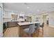 Bright kitchen with white cabinets, two-tone island, stainless appliances and modern fixtures and hardware at 8007 17Th Nw Ave, Bradenton, FL 34209