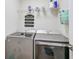 Laundry room with front load washer and dryer and wire shelving for storage at 8007 17Th Nw Ave, Bradenton, FL 34209